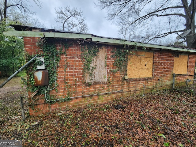 view of side of home featuring brick siding