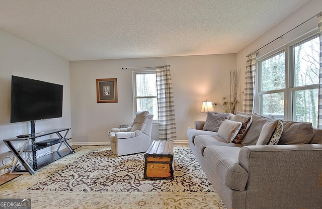 living room featuring a textured ceiling and baseboards