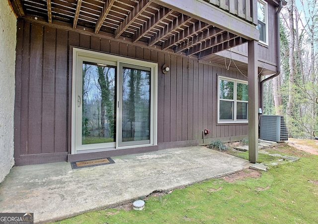 entrance to property with central air condition unit and a patio