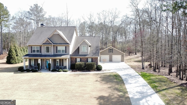 114 Austin Storey Cir, Newnan, GA 30263 - view of front of property featuring an outbuilding, covered porch, driveway, a detached garage, and a chimney