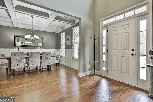 114 Austin Storey Cir, Newnan, GA 30263 - entrance foyer with beamed ceiling, wood finished floors, a chandelier, healthy amount of natural light, and coffered ceiling