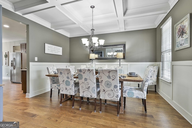114 Austin Storey Cir, Newnan, GA 30263 - dining area featuring a chandelier, coffered ceiling, beam ceiling, wood finished floors, and a wainscoted wall