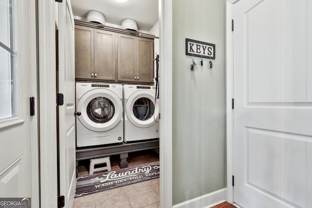 laundry area featuring cabinet space, independent washer and dryer, and tile patterned floors