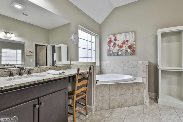 bathroom featuring visible vents, a garden tub, tile patterned flooring, lofted ceiling, and vanity