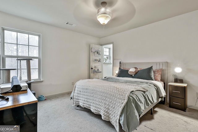 carpeted bedroom featuring visible vents, ceiling fan, and baseboards