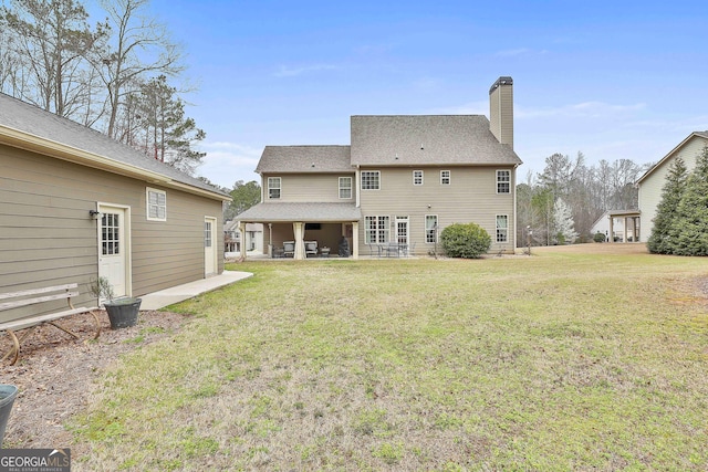 114 Austin Storey Cir, Newnan, GA 30263 - back of house featuring a chimney, a patio area, and a yard