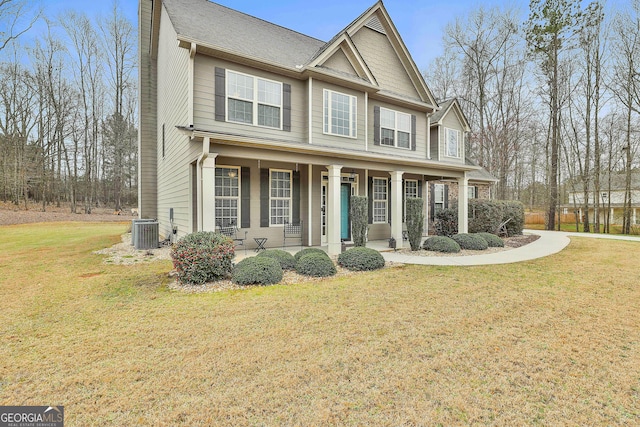 view of front of property featuring a chimney, covered porch, central AC, and a front yard