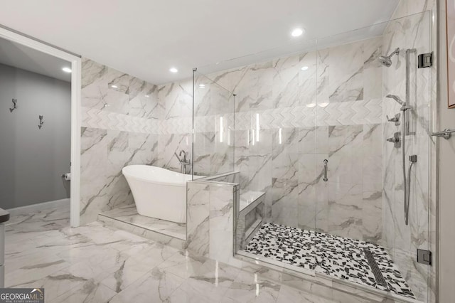 full bath with recessed lighting, marble finish floor, a freestanding bath, and a marble finish shower