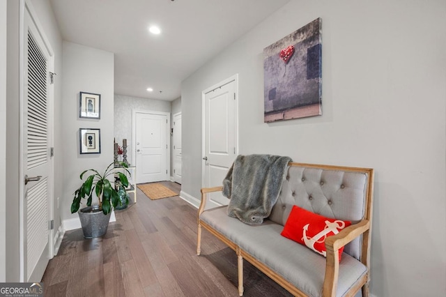 corridor featuring recessed lighting, wood finished floors, and baseboards