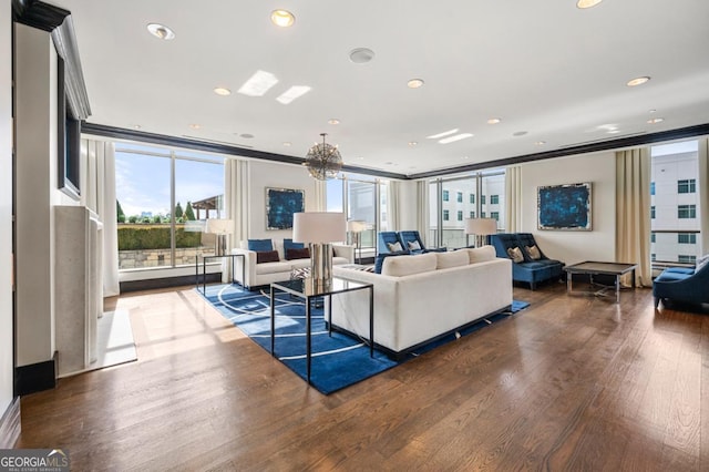 living area with expansive windows, recessed lighting, wood finished floors, and an inviting chandelier