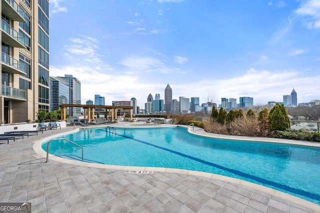 pool featuring a view of city and a patio