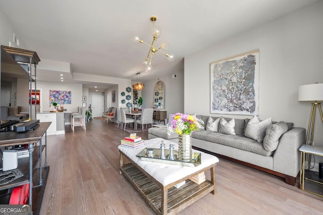 living room featuring a chandelier and wood finished floors