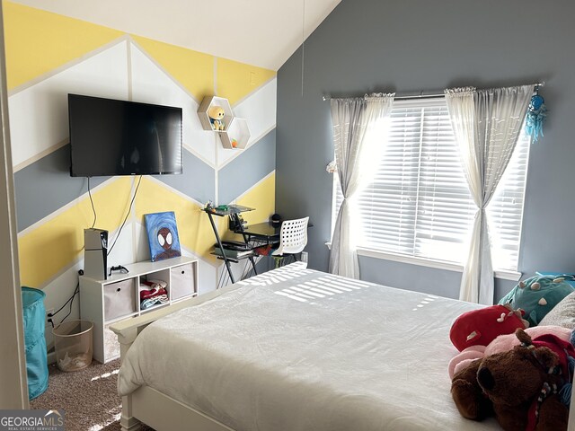 bedroom with lofted ceiling and carpet flooring