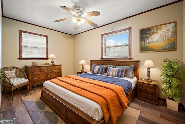 bedroom with a ceiling fan, crown molding, and wood finished floors