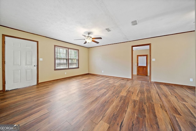 unfurnished living room with a ceiling fan, a textured ceiling, baseboards, and wood finished floors