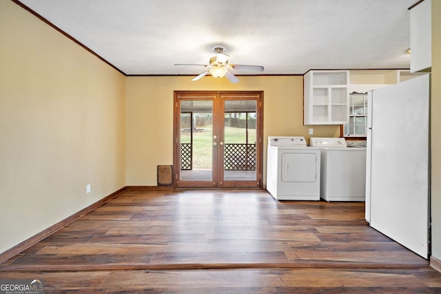 washroom featuring french doors, ornamental molding, wood finished floors, washer and dryer, and baseboards