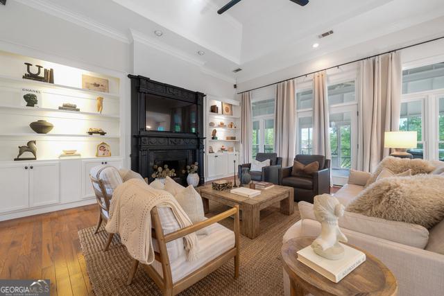 living room with a healthy amount of sunlight, hardwood / wood-style flooring, a fireplace, and visible vents