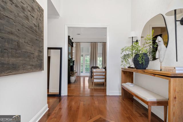 hallway with baseboards and wood finished floors