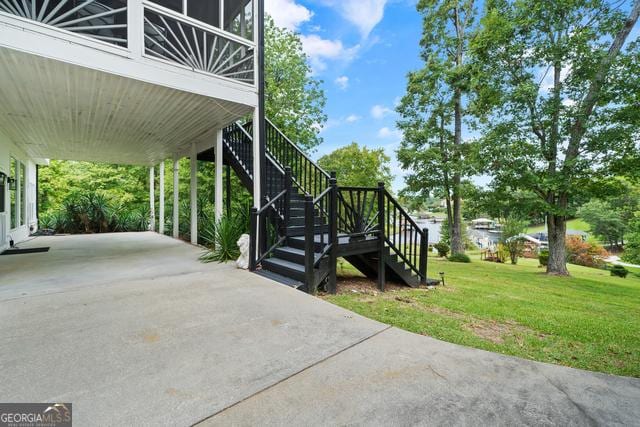 exterior space featuring concrete driveway and stairway