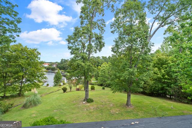 view of community featuring a lawn and a water view