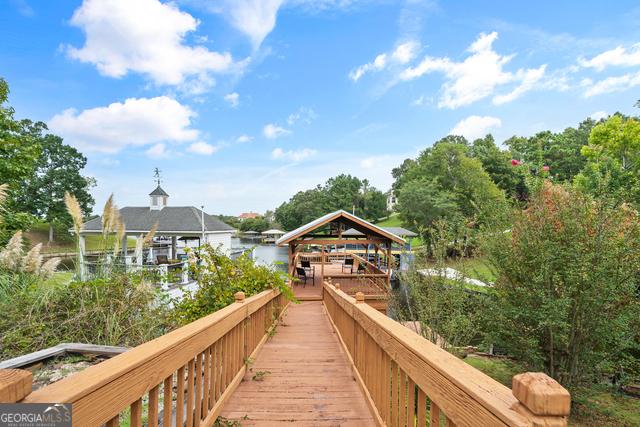 view of dock with a gazebo and a water view