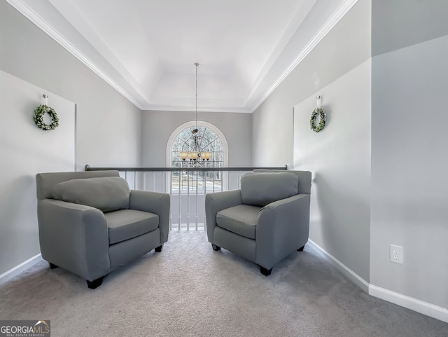 sitting room featuring carpet floors, a tray ceiling, baseboards, and a notable chandelier