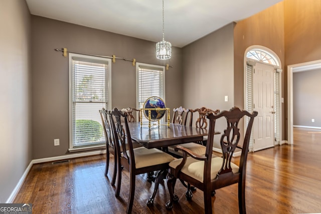 dining area with visible vents, baseboards, and wood finished floors