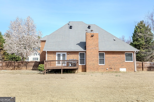 back of property with brick siding, a fenced backyard, and a wooden deck