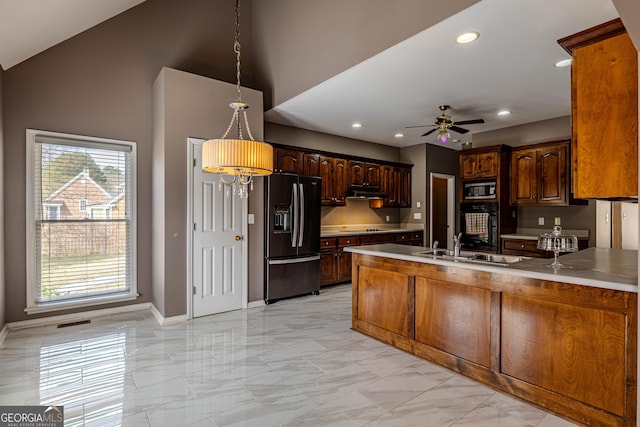 kitchen with a peninsula, black appliances, ceiling fan, and marble finish floor