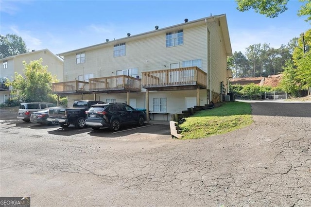 rear view of house featuring uncovered parking