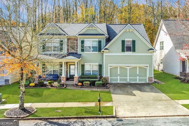 view of front facade featuring a front lawn, a shingled roof, a garage, and concrete driveway