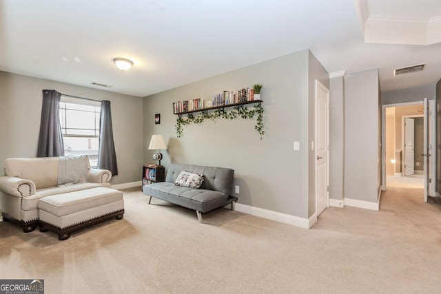 living area with light colored carpet, baseboards, and visible vents