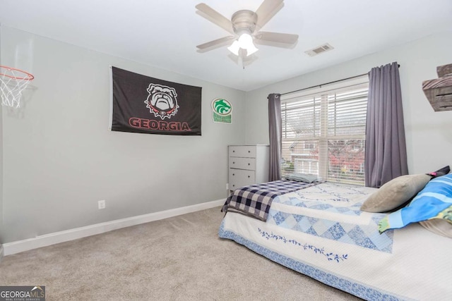 carpeted bedroom featuring baseboards, visible vents, and ceiling fan