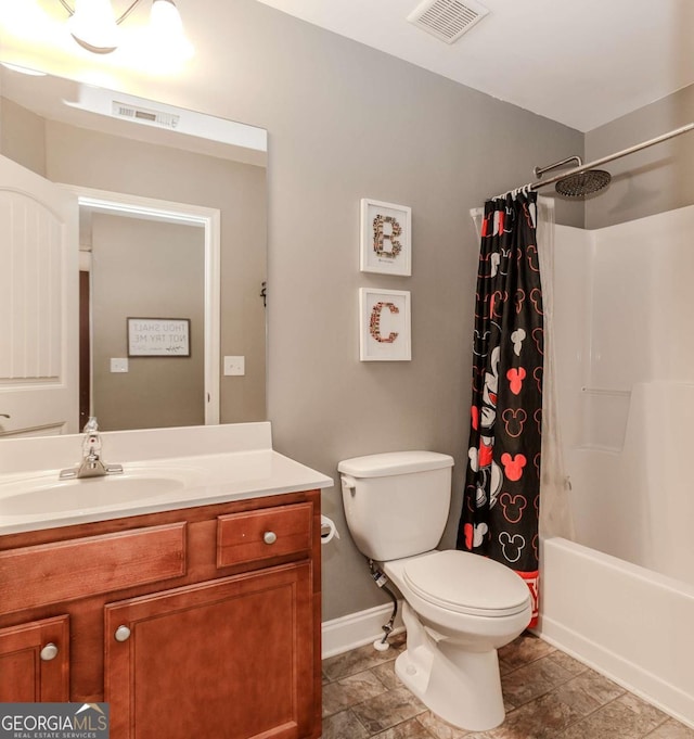 bathroom featuring toilet, visible vents, baseboards, and vanity
