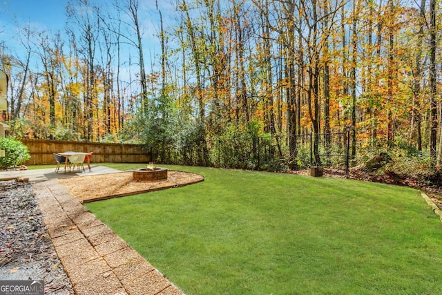 view of yard featuring an outdoor fire pit, a patio area, and a fenced backyard