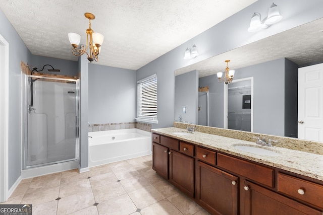 bathroom featuring a chandelier, double vanity, a sink, and a shower stall