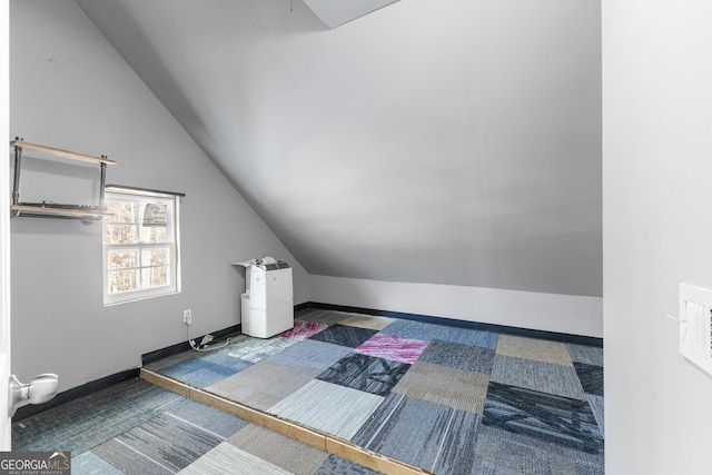 additional living space with lofted ceiling and baseboards