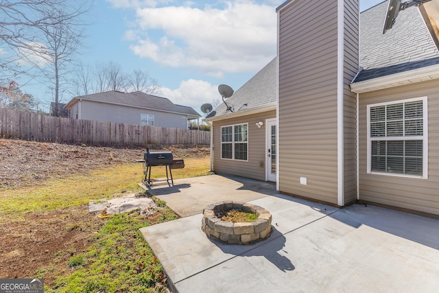 view of patio / terrace with a fire pit and fence