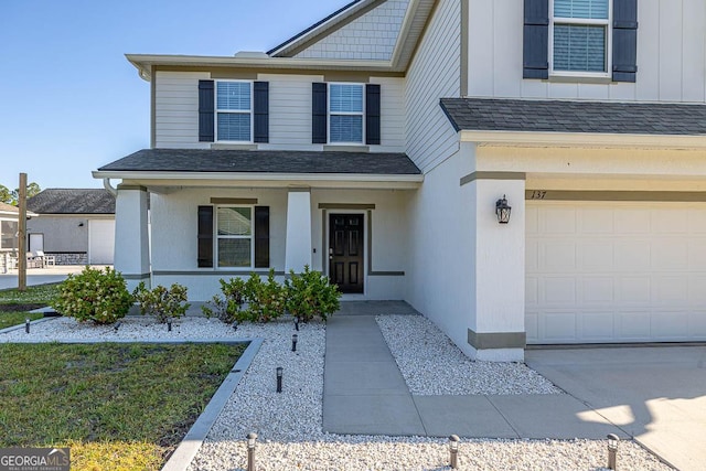 137 Walnut Way, Kingsland, GA 31548 - view of front facade with a garage, covered porch, and roof with shingles