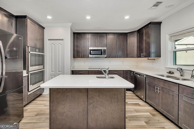 137 Walnut Way, Kingsland, GA 31548 - kitchen with appliances with stainless steel finishes, crown molding, a sink, light wood-style floors, and recessed lighting