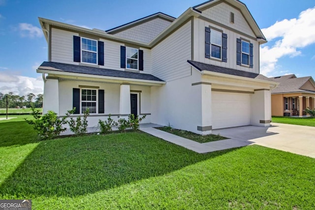 view of front of home with a garage, a front lawn, concrete driveway, and stucco siding