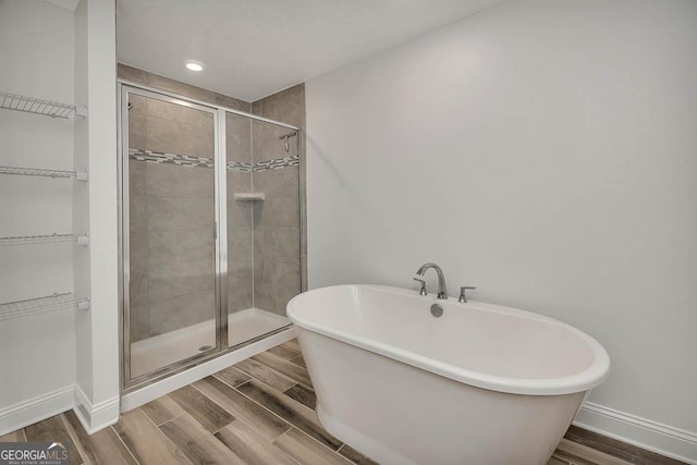 137 Walnut Way, Kingsland, GA 31548 - full bathroom with a freestanding tub, a shower stall, a spacious closet, and recessed lighting