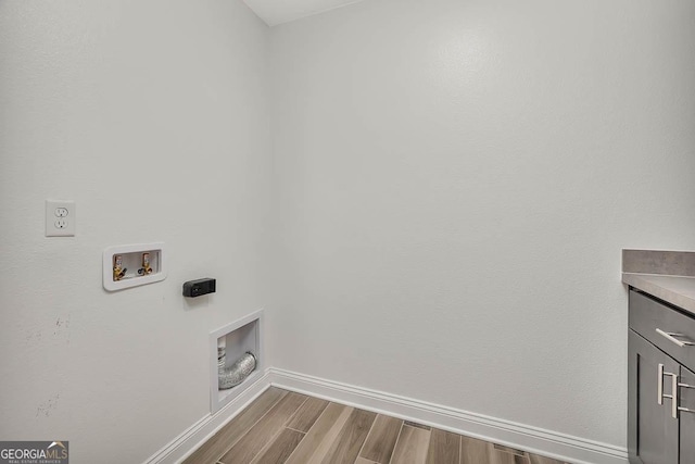137 Walnut Way, Kingsland, GA 31548 - washroom featuring hookup for a washing machine, cabinet space, dark wood-style floors, baseboards, and hookup for an electric dryer