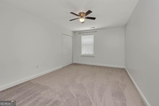 137 Walnut Way, Kingsland, GA 31548 - empty room featuring light colored carpet, a ceiling fan, and baseboards