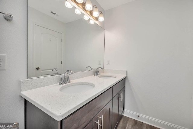 137 Walnut Way, Kingsland, GA 31548 - bathroom with double vanity, wood finished floors, and baseboards