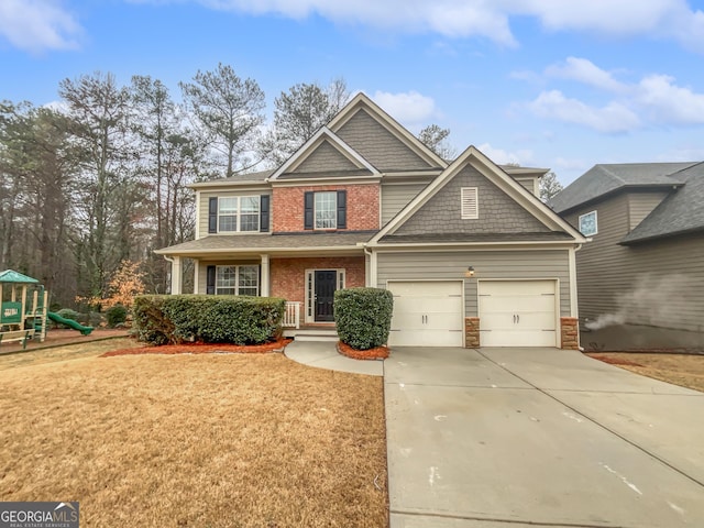 craftsman inspired home featuring a garage, driveway, a playground, and a front yard