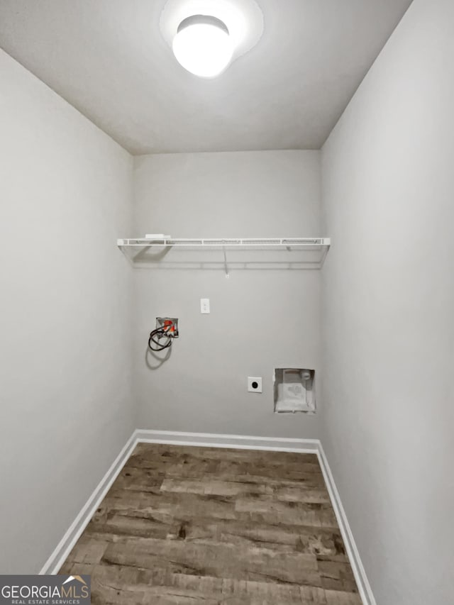 clothes washing area with laundry area, baseboards, wood finished floors, hookup for a washing machine, and electric dryer hookup