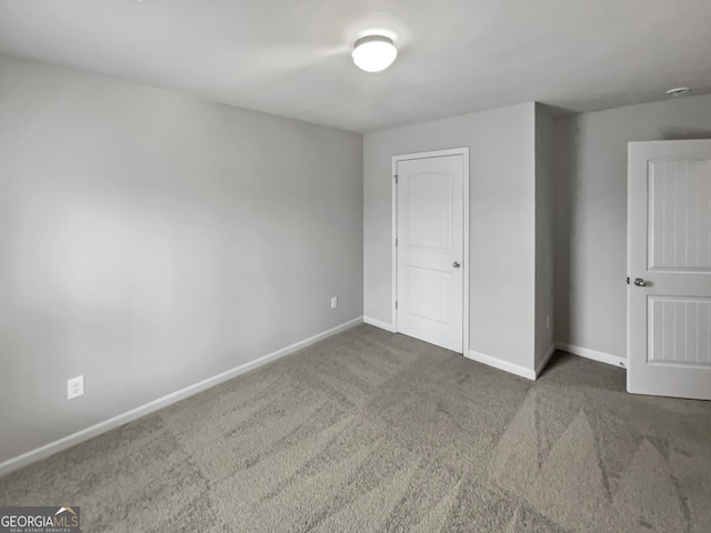 unfurnished bedroom featuring carpet floors and baseboards