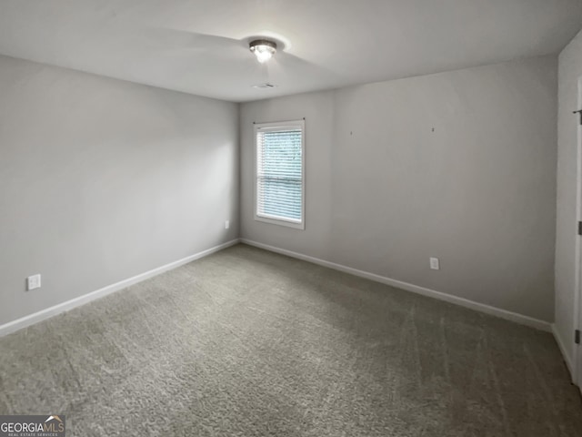 carpeted spare room with baseboards