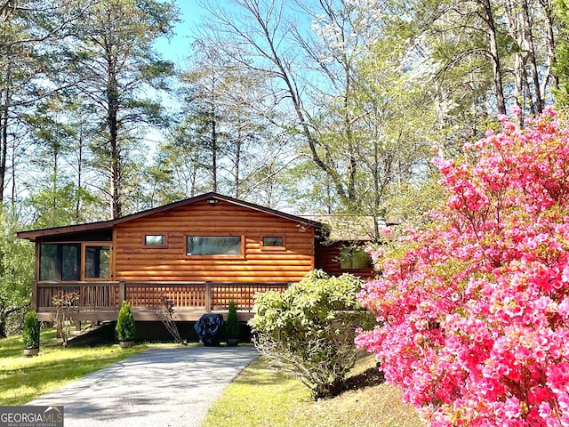 exterior space with a sunroom and driveway